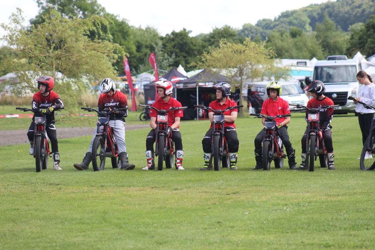 Young riders in full protective gear — helmets, pads, gloves and boots